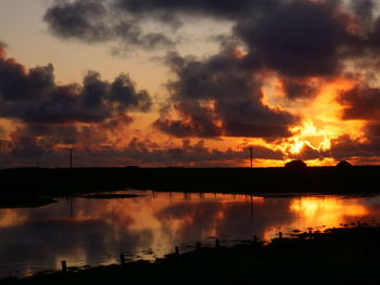 Scenic view of lake against romantic sky at sunset