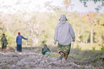 Rear view of father and son walking outdoors