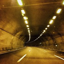 Illuminated tunnel at night