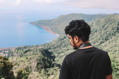 Rear view of man looking at mountains