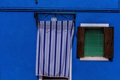 Low angle view of blue window of building