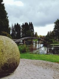 Bridge over calm lake against sky