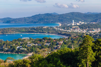 High angle view of city by sea against sky