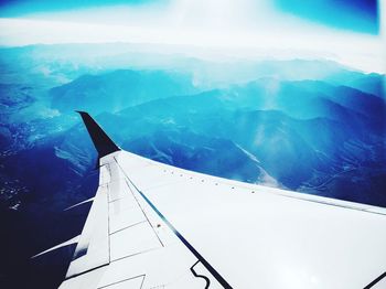 Aerial view of airplane wing over landscape