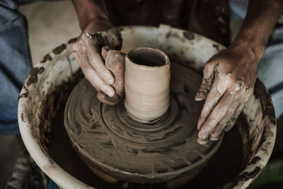 Close-up of artist making pot at workshop