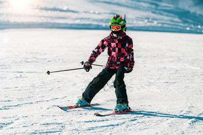 Full length portrait of man skiing on snow