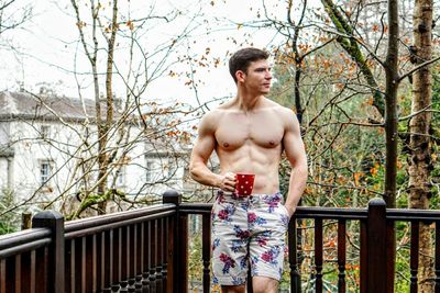 Portrait of shirtless man on balcony