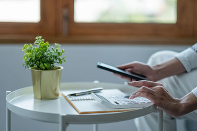 Midsection of man working on table