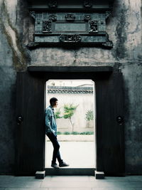 Young man standing in doorway