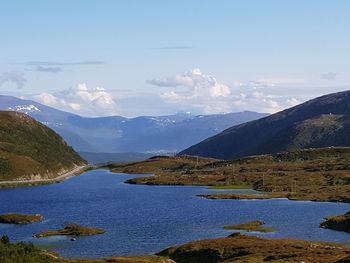 Scenic view of lake and mountains against sky