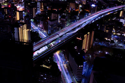 High angle view of illuminated buildings in city at night