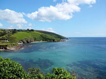 Scenic view of sea and coast against sky