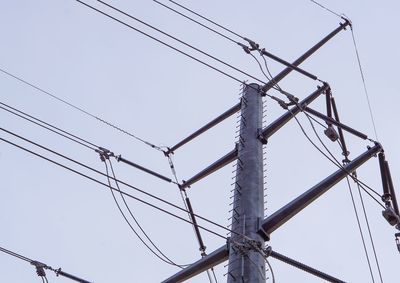 Low angle view of electricity pylon against sky