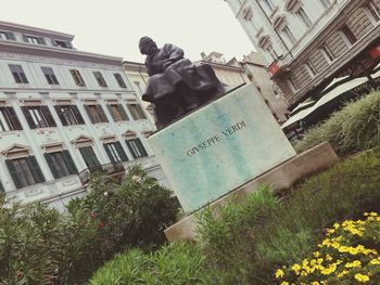 Low angle view of statue in city against sky