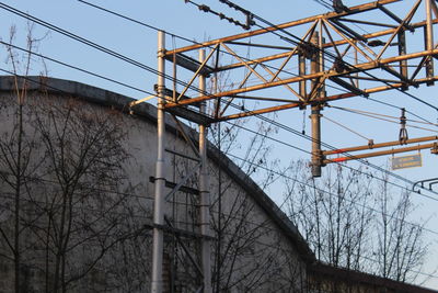 Low angle view of electricity pylon against sky