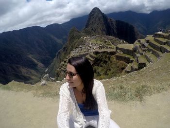 Young woman against machu picchu incan ruins