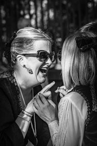 Portrait of young woman with arms raised