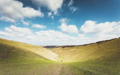 Scenic view of landscape against cloudy sky