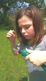 Beautiful young woman with hand on grass