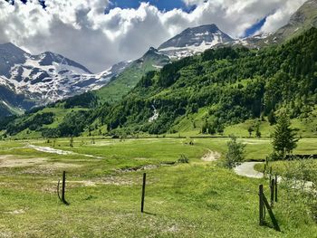 Scenic view of field and mountains against sky