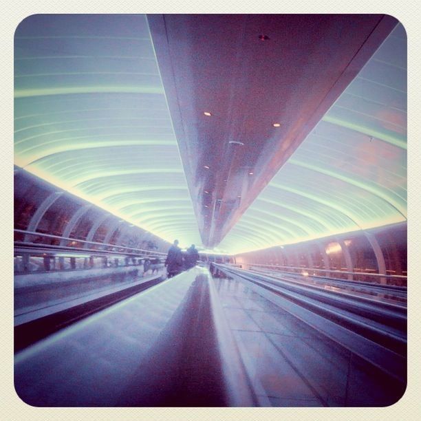 transportation, indoors, the way forward, diminishing perspective, vanishing point, illuminated, tunnel, transfer print, rail transportation, architecture, blurred motion, public transportation, railroad track, travel, built structure, ceiling, railroad station, empty, motion, railroad station platform