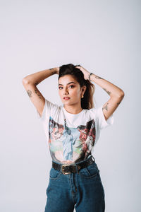 Portrait of a beautiful young woman against white background