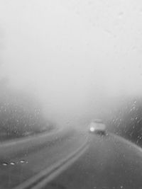 Full frame shot of wet glass window in rainy season