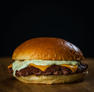 Close-up of burger against black background