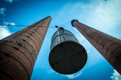 Directly below shot of elevator amidst chimneys