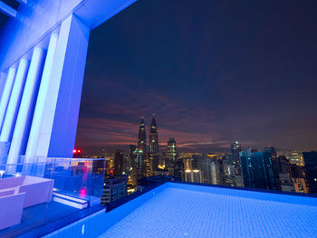 Illuminated cityscape against sky at night