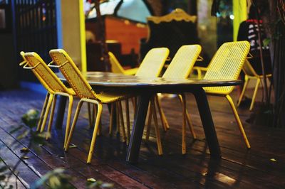 Empty chairs at table in restaurant