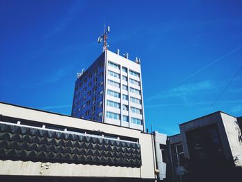 Low angle view of modern building against clear blue sky