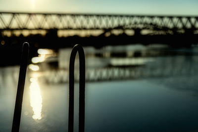 Close-up of illuminated bridge against sky during sunset