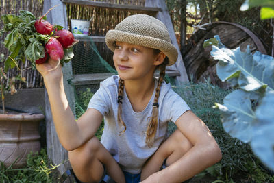 Midsection of girl holding plants