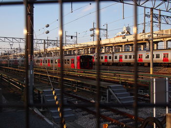 Train at railroad station in city against sky