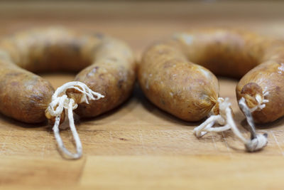 Portuguese smoked sausage called alheira on wooden board