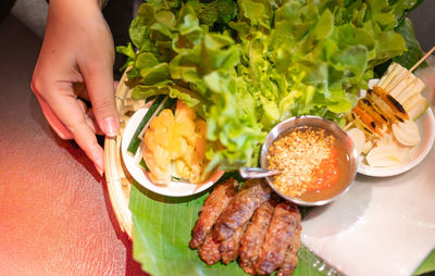 Female hand serving the set of traditional food famous in vietnam, the local vietnam food.