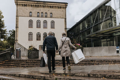 Couple walking in city with shopping bags