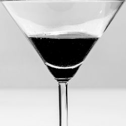 Close-up of beer on table against white background