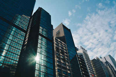 Low angle view of modern buildings in city against sky