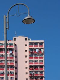 Low angle view of modern building against clear blue sky