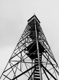 Low angle view of communications tower against sky