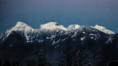 Scenic view of snowcapped mountains against sky