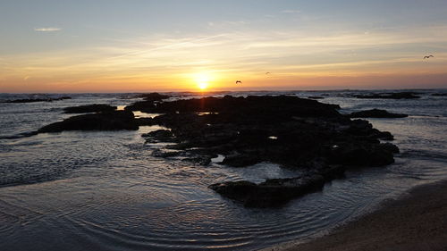 Scenic view of sea against sky during sunset