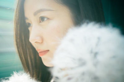 Close-up portrait of young woman looking away