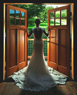 Rear view of woman standing in corridor