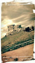 Scenic view of landscape against cloudy sky