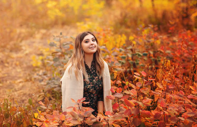 Portrait of a smiling young woman during autumn
