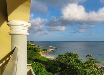 Close-up of lighthouse by sea against sky