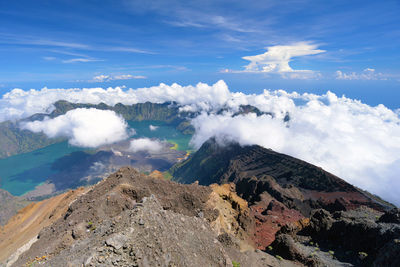 Scenic view of clouds over volcanic landscape against sky